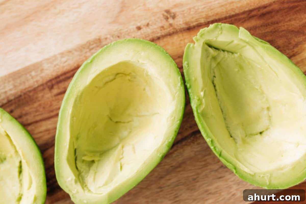 Avocado Scrambled Egg Boats 4 Avocados pitted, halved and peeled, ready to get stuffed with cheese mixture