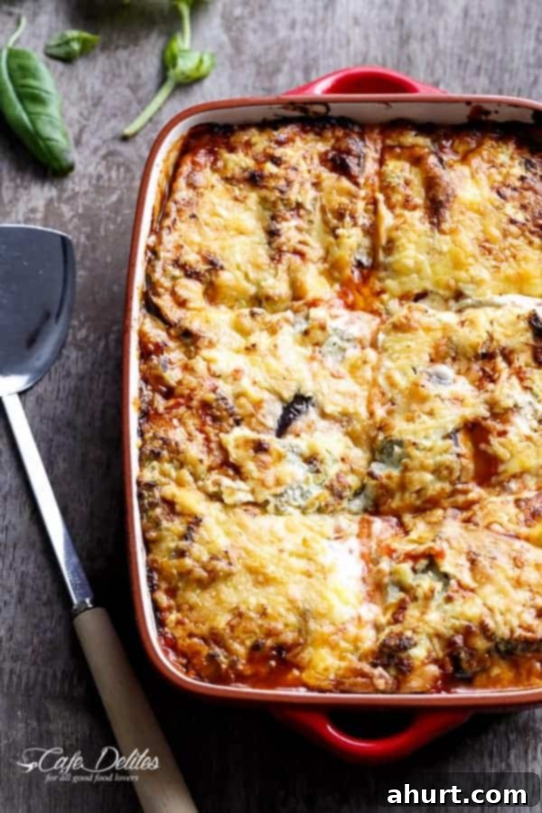 Baked image of Sausage Eggplant Lasagna With Ricotta Pesto, showing a golden-brown, bubbling cheese top.