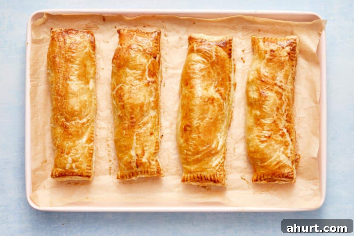 Flaky Salmon and Spinach Pockets 11 Freshly baked golden salmon parcels on a tray, straight from the oven.