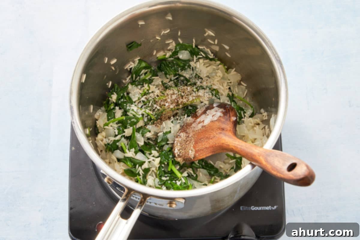 Flaky Salmon and Spinach Pockets 6 Mixing parsley and lemon juice into the cooked spinach and rice mixture.