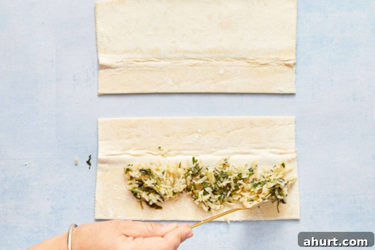 Flaky Salmon and Spinach Pockets 8 Spooning spinach and rice mixture onto the bottom half of the pastry sheet.