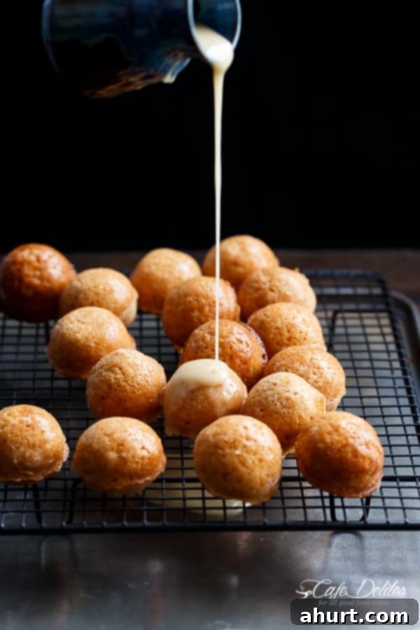 Baked Maple Glazed Apple Fritter Donut Holes on a cooling rack, freshly baked
