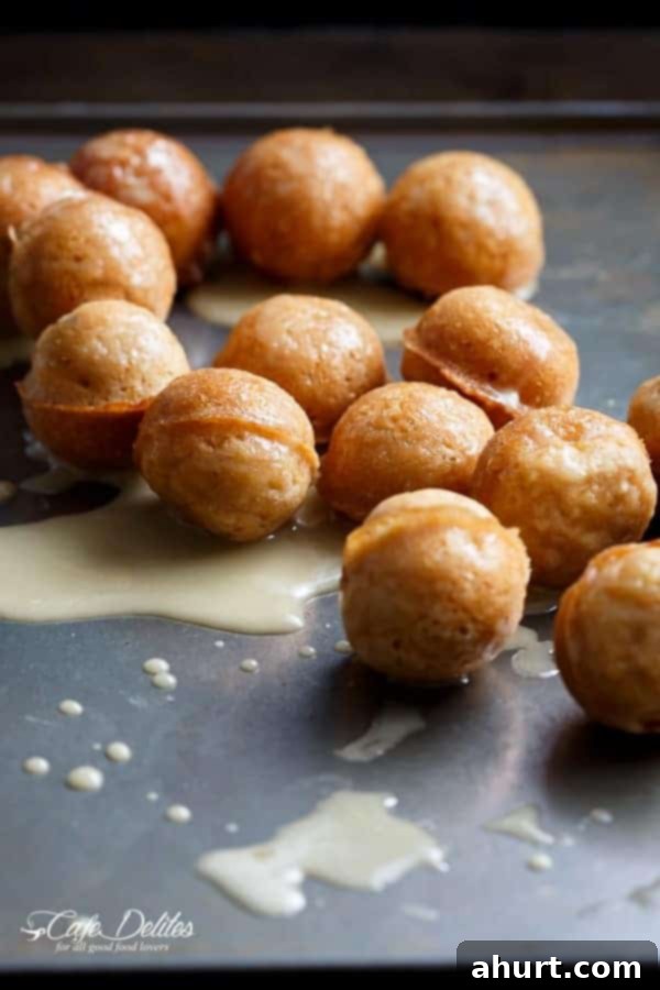 Golden baked maple glazed apple fritter donut holes arranged artfully for serving