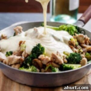 Velvety White Wine Chicken and Mushroom Delight 7 Chicken and Mushrooms in a Creamy White Wine Sauce in a pan