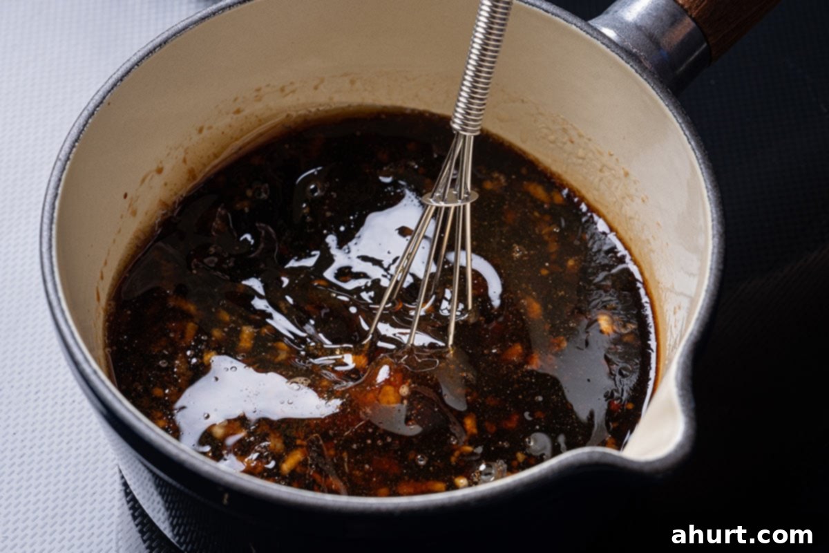 Caramelized Asian Glazed Chicken Thighs 4 sauce simmering in a saucepan for Asian glazed chicken