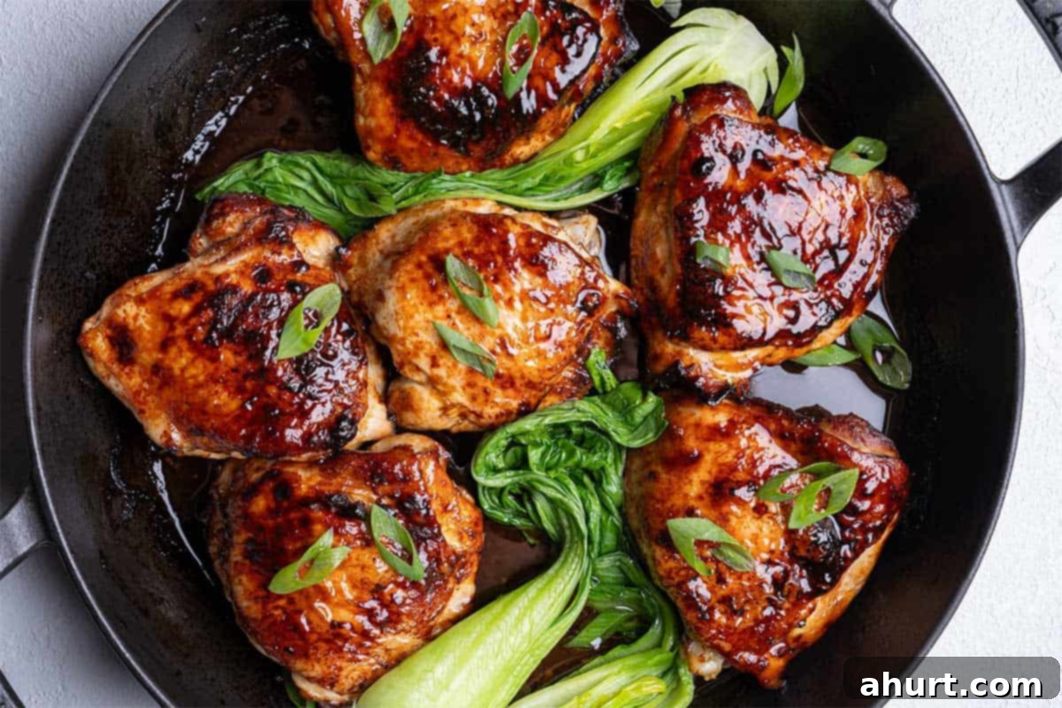 Caramelized Asian Glazed Chicken Thighs 7 chicken in a skillet juicy and with bok choy, ready to serve