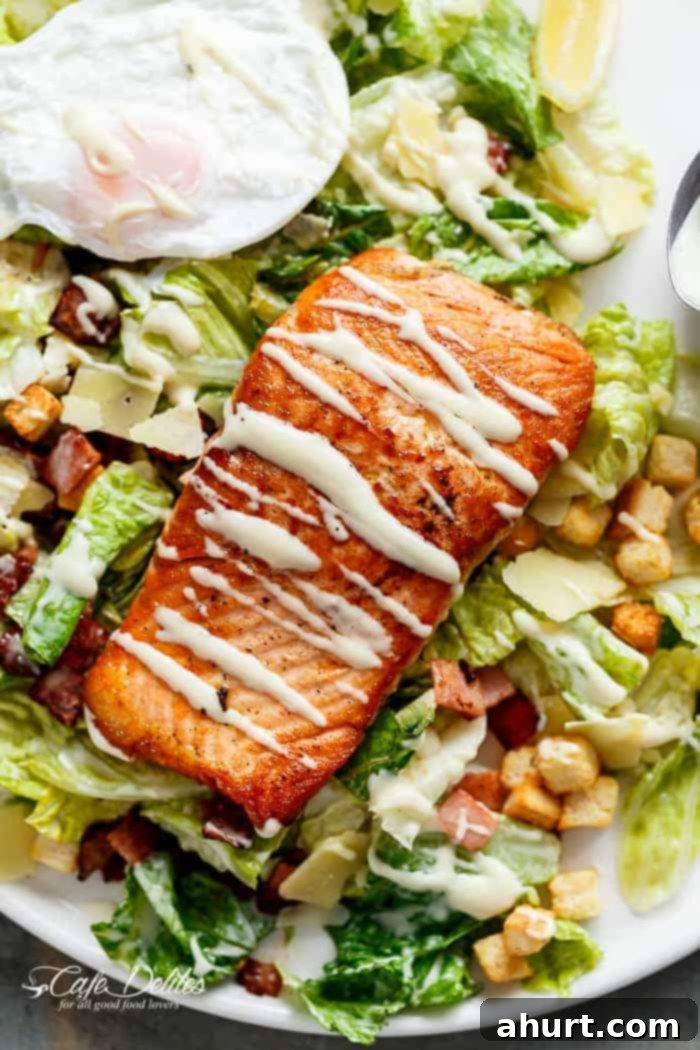 Crispy pan-fried Salmon with creamy avocado, crunchy croutons, shaved parmesan, a runny poached egg, and light Caesar dressing
