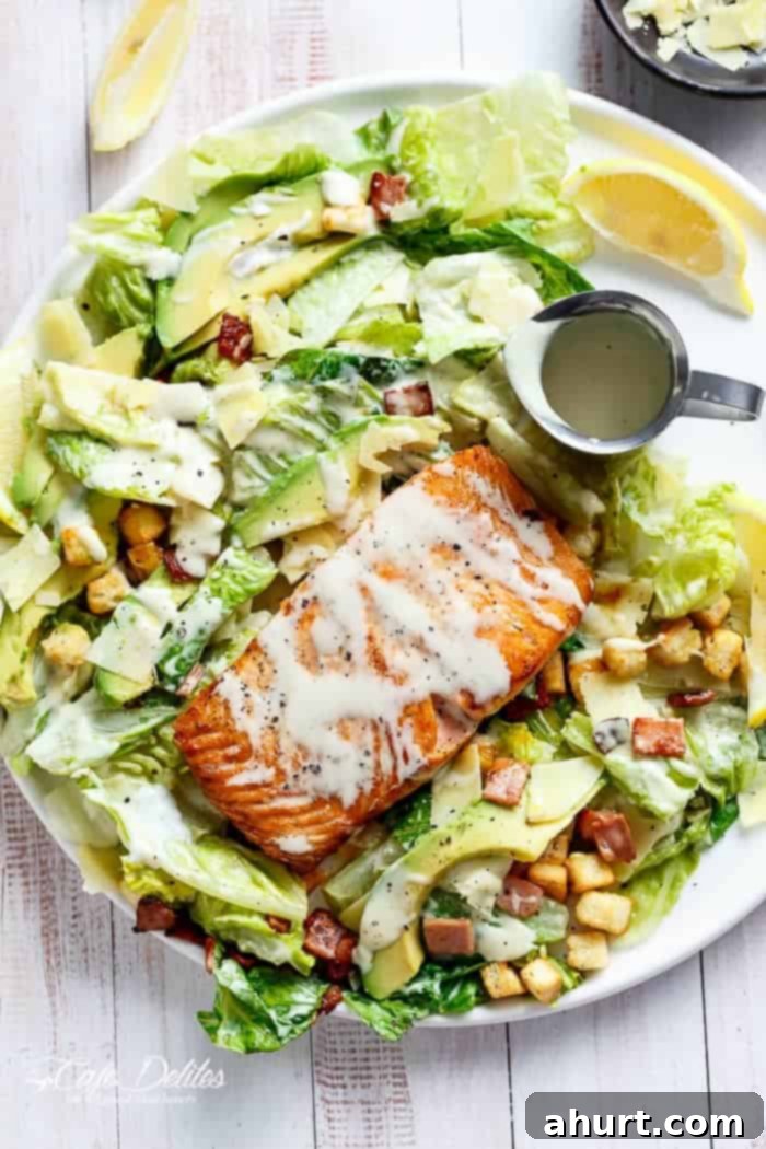 Crispy pan-fried Salmon and Avocado Caesar Salad with creamy avocado, crunchy croutons, shaved parmesan, a runny poached egg, and a lightened-up Caesar dressing!