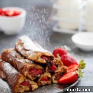 French Toast Rolls Breakfast Perfection 11 Gingerbread French Toast Roll Ups on a plate, garnished with powdered sugar.