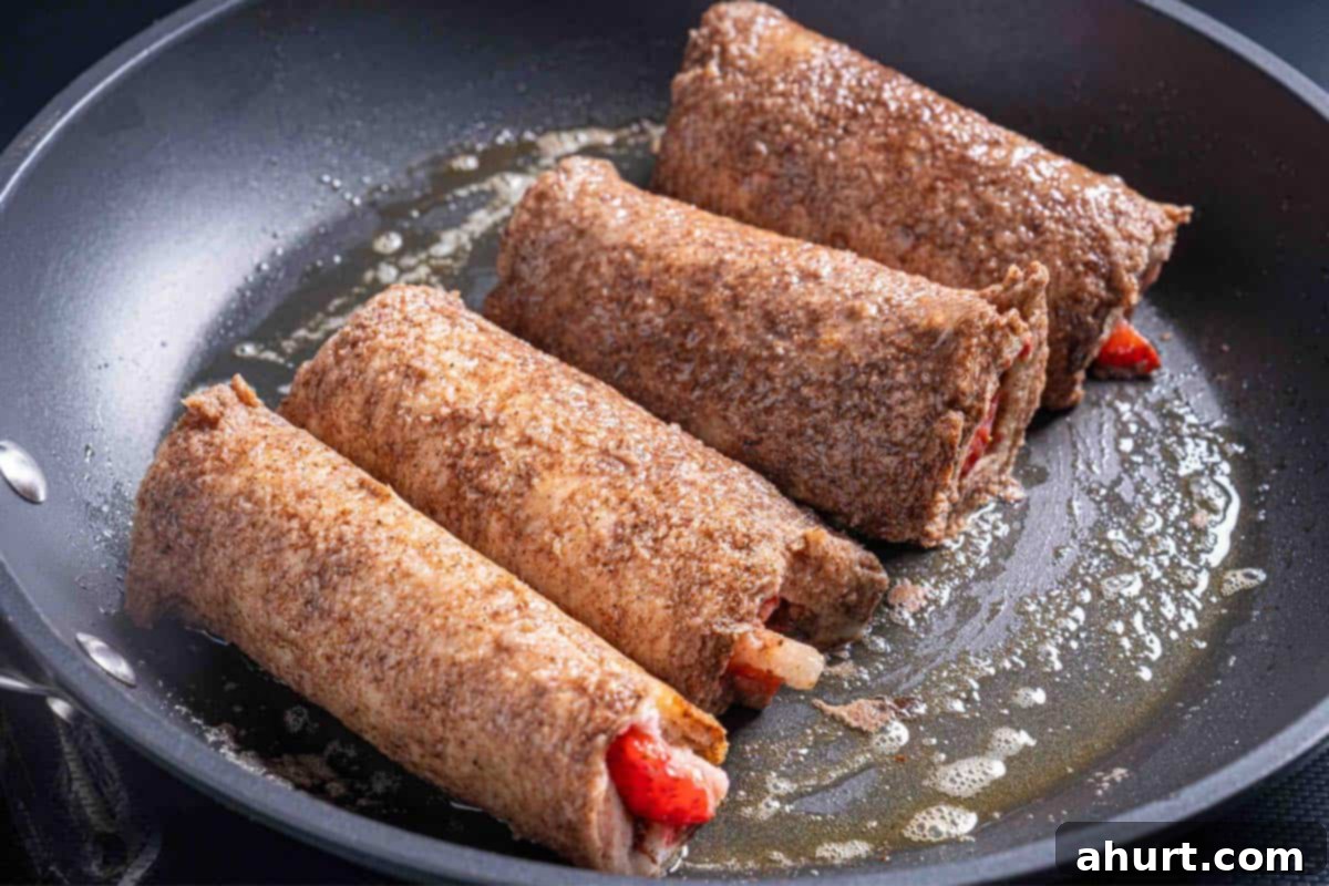 French Toast Rolls Breakfast Perfection 9 Image of the dipped rolls being cooked in a skillet until golden brown.