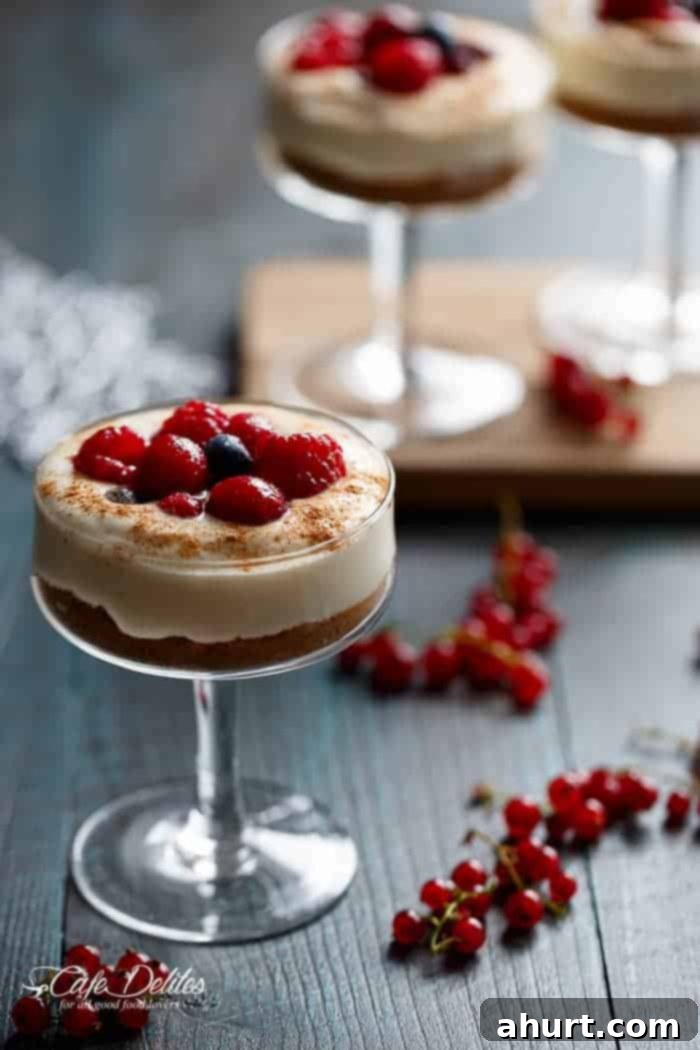 Effortless Eggnog Berry Cheesecakes 2 Side view of No Bake EggNog Berry Cheesecakes in a glass