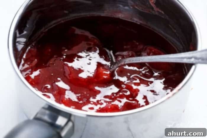 Close-up of Berry Limoncello Moscato Sangria mixture in a pitcher, showing the vibrant colors of berries and wine.