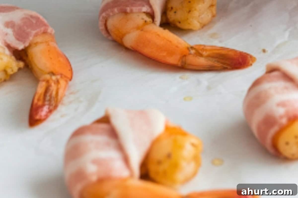 Irresistible Bacon-Wrapped Prawns 8 Wrap one bacon strip around each shrimp. Repeat until all the shrimps are wrapped.