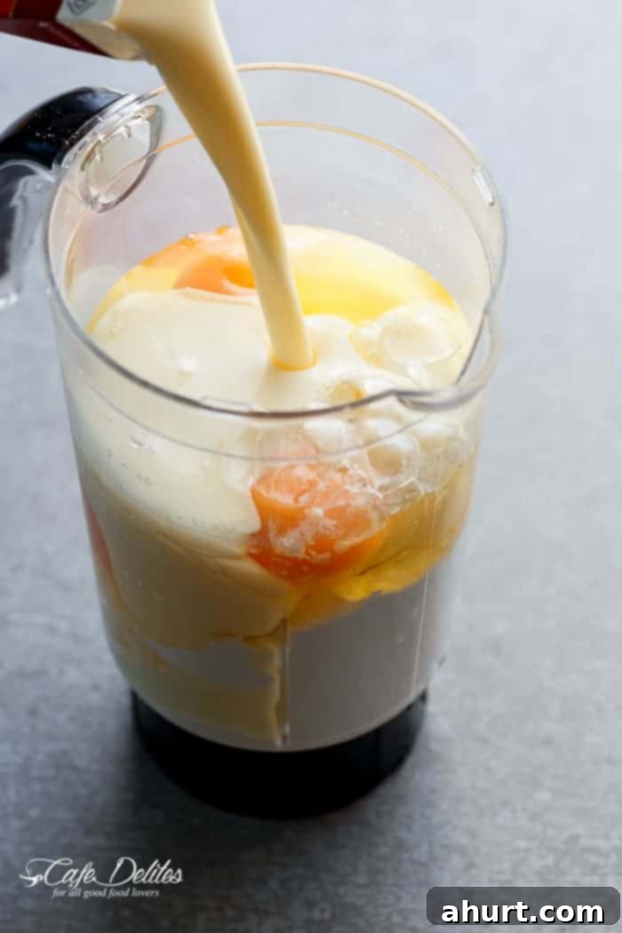 Close-up of smooth, creamy eggnog crêpe batter in a glass blender pitcher