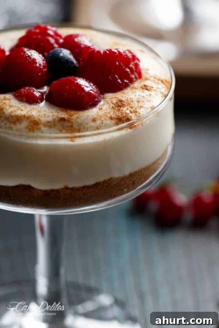 Blender Eggnog Crêpes topped with a dollop of creamy filling and a generous sprinkle of fresh berries