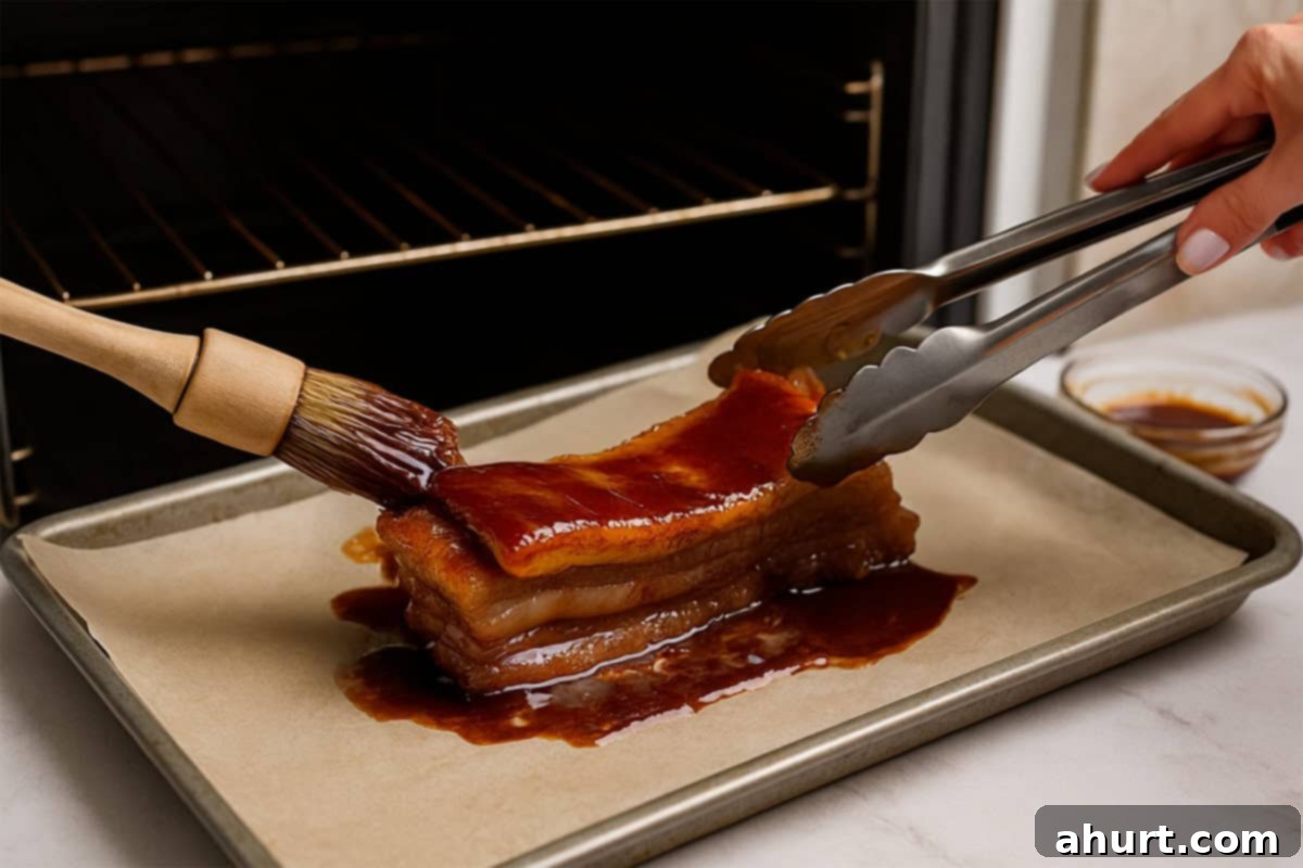 Glazed Char Siu Pork Belly 6 Raw marinated pork belly on a foil-lined baking tray, ready to be placed in the oven for roasting.