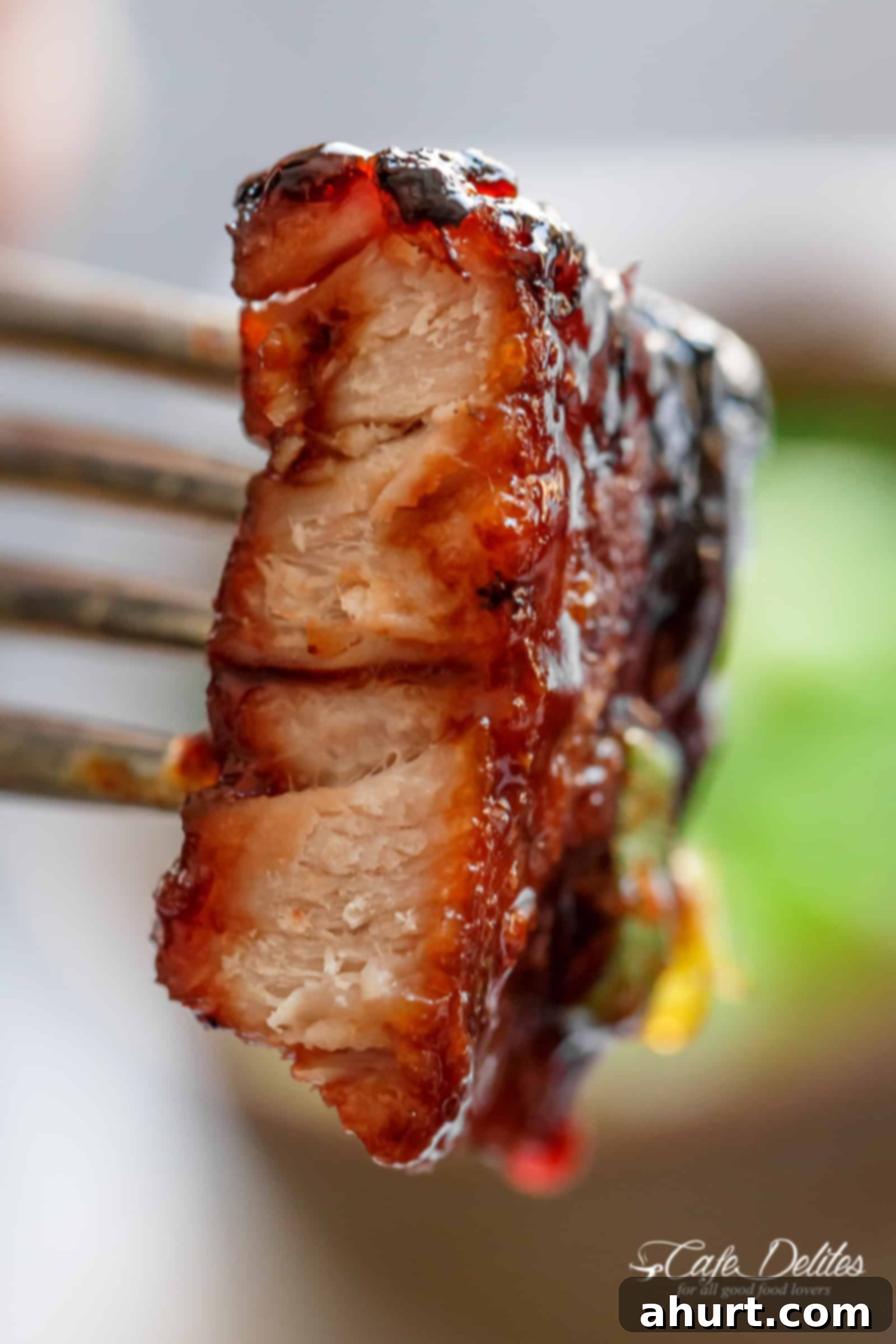 Glazed Char Siu Pork Belly 10 Sticky Chinese Barbecue Pork Belly (Char Siu) on a plate, close-up with a vibrant red glaze.