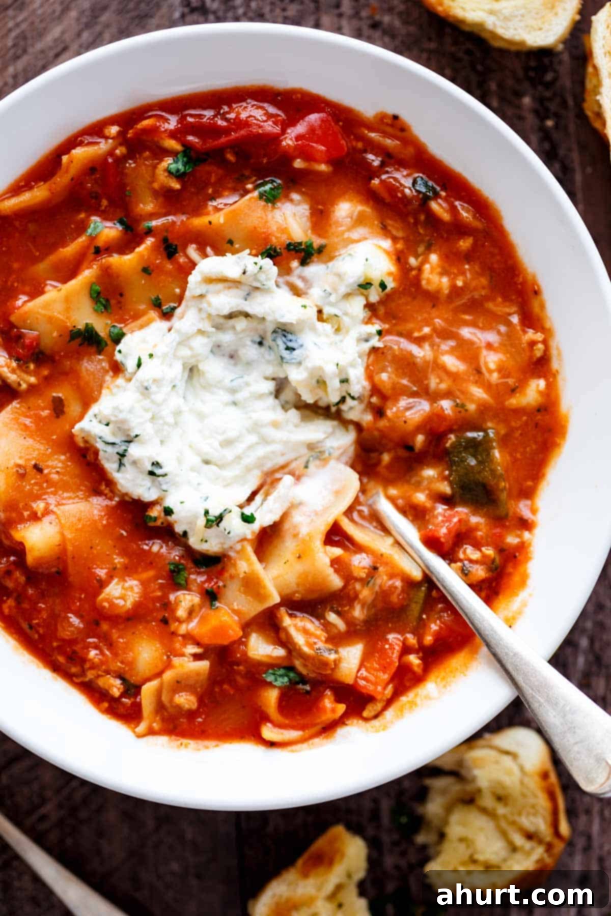 Cozy Slow Cooker Lasagna Soup 2 Lasagna Soup with some cream cheese on top with spoon