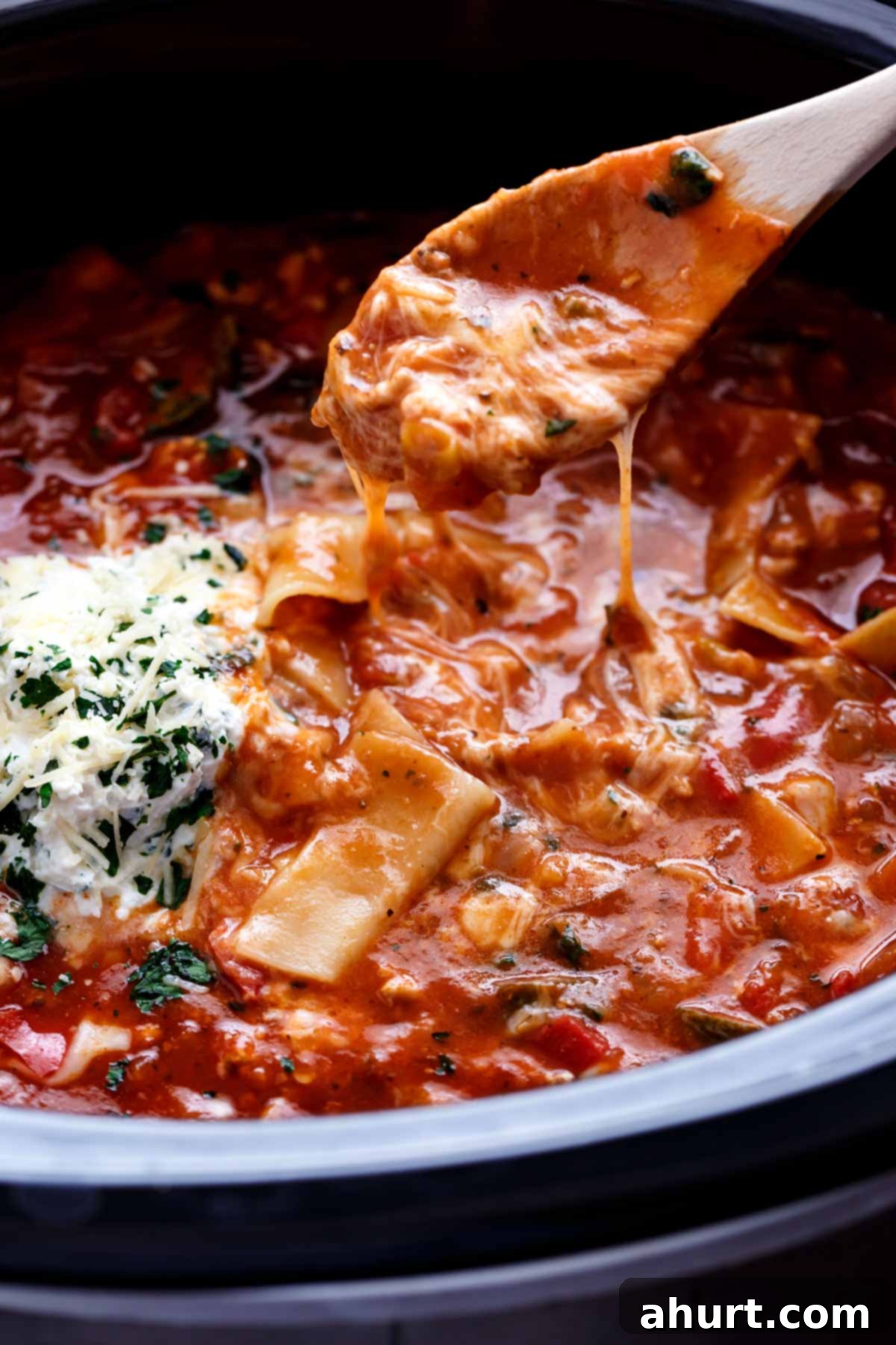 Cozy Slow Cooker Lasagna Soup 3 Lasagna Soup in a bowl with wooden spoon