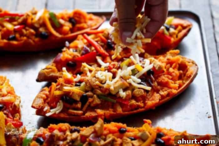 Shredded cheese on Twice Baked Chicken Fajita Sweet Potatoes 