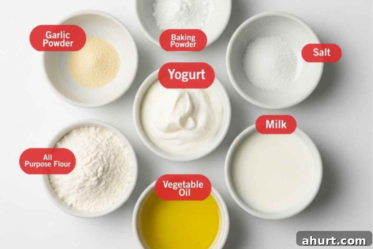 Simple Yeast-Free Flatbread Recipe 3 Flay lay photo of ingredient shot of garlic powder, baking powder, yogurt, salt, all purpose flour, vegetable oil and milk