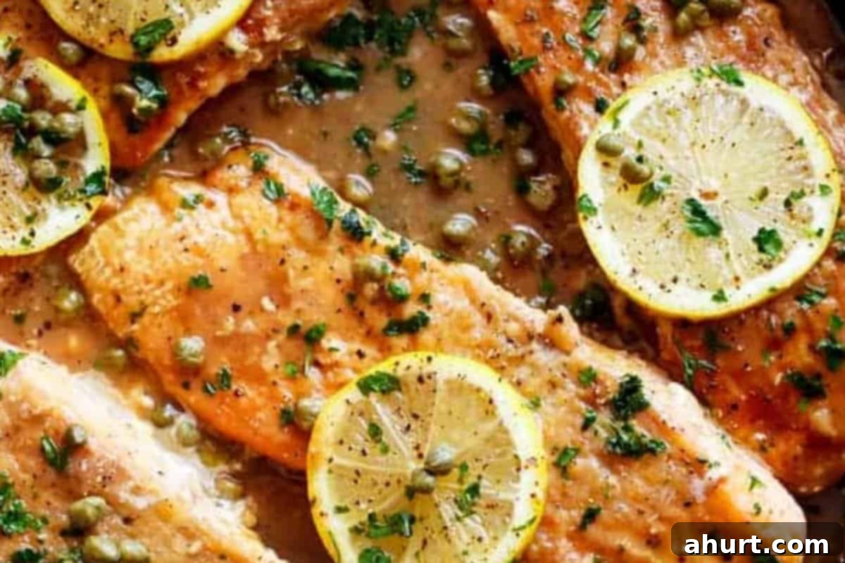 Quick Lemon Caper Salmon 11 Finished salmon piccata dish, garnished with fresh parsley and lemon slices.
