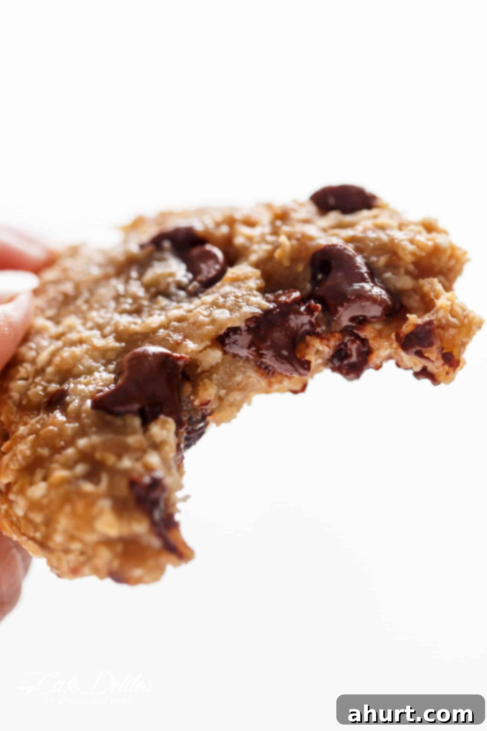 Healthy 2 Ingredient Breakfast Cookies 3 A breakfast cookie with a bite missing and melting chocolate in the middle.