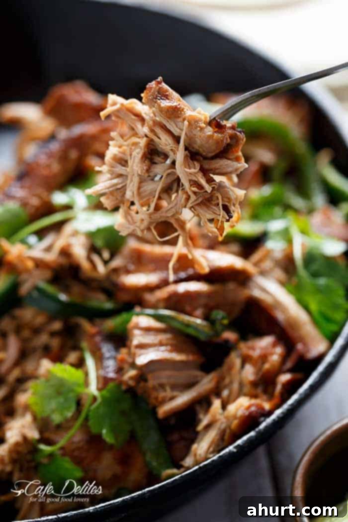 Crispy Slow Cooker Pork Carnitas pieces in fork