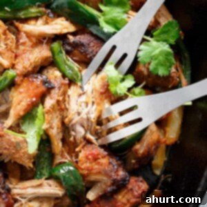 Crispy Slow Cooker Mexican Pulled Pork Carnitas 14 Fork pierced in Crispy Slow Cooker Carnitas