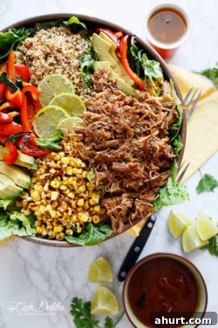 A vibrant Chipotle Lime Carnitas Salad, drizzled with dressing, featuring crispy carnitas and cilantro lime cauliflower rice, ready to be served.