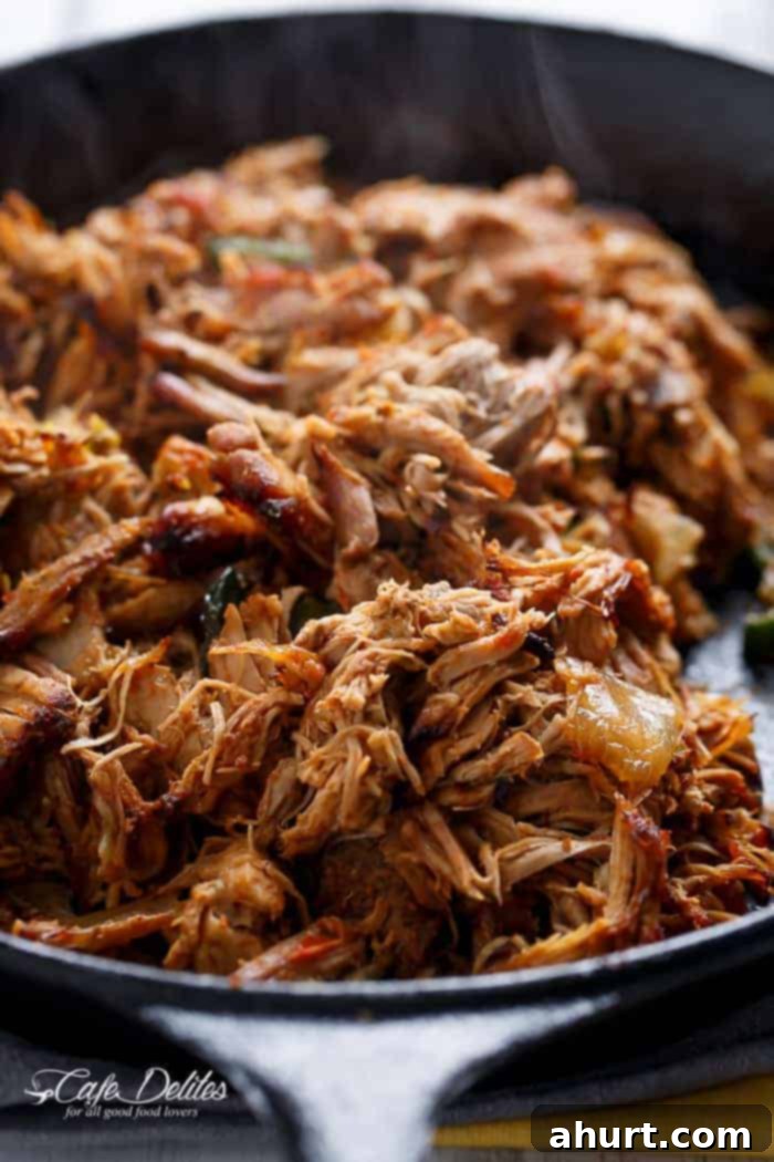 Close-up of succulent crispy carnitas in a healthy Chipotle Lime Salad, highlighting the delicious texture.