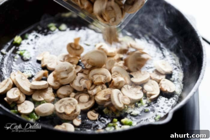 Mushroom slices getting fried in a pan