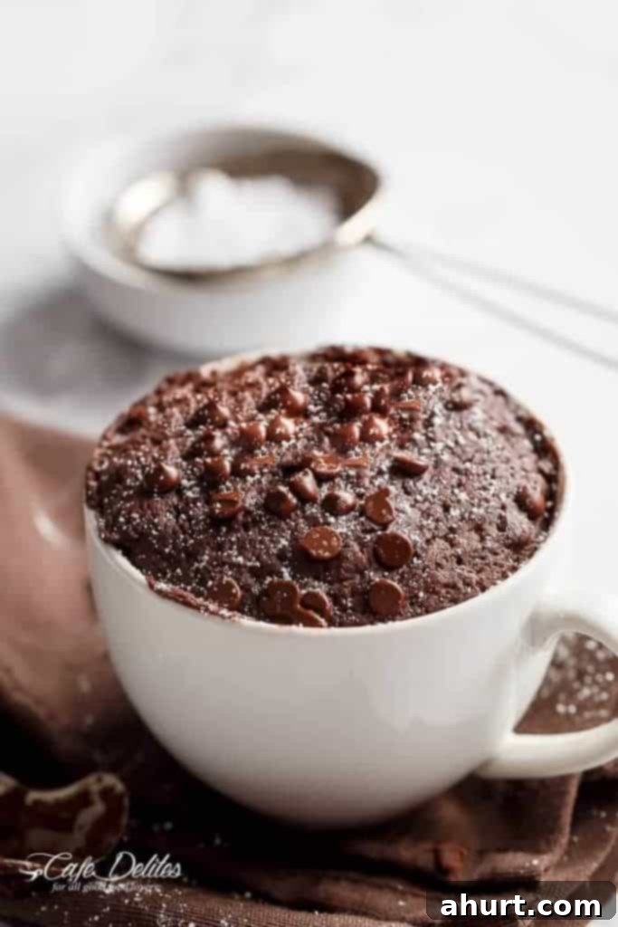 Guilt-Free Chocolate Mug Cake 2 Fluffy, Buttery, and Soft yet Low Fat Chocolate in Mug Cake, ready to eat with a spoon inserted