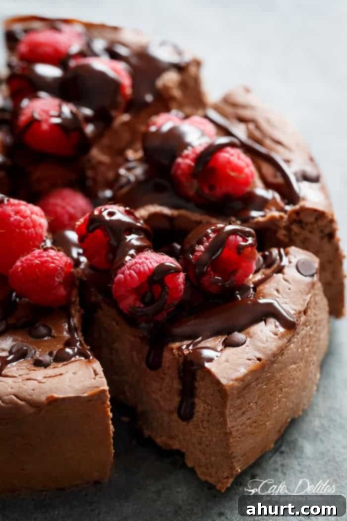 A slice of Crustless Chocolate Raspberry Cheesecake with a bite taken out, showing the creamy interior and raspberries.