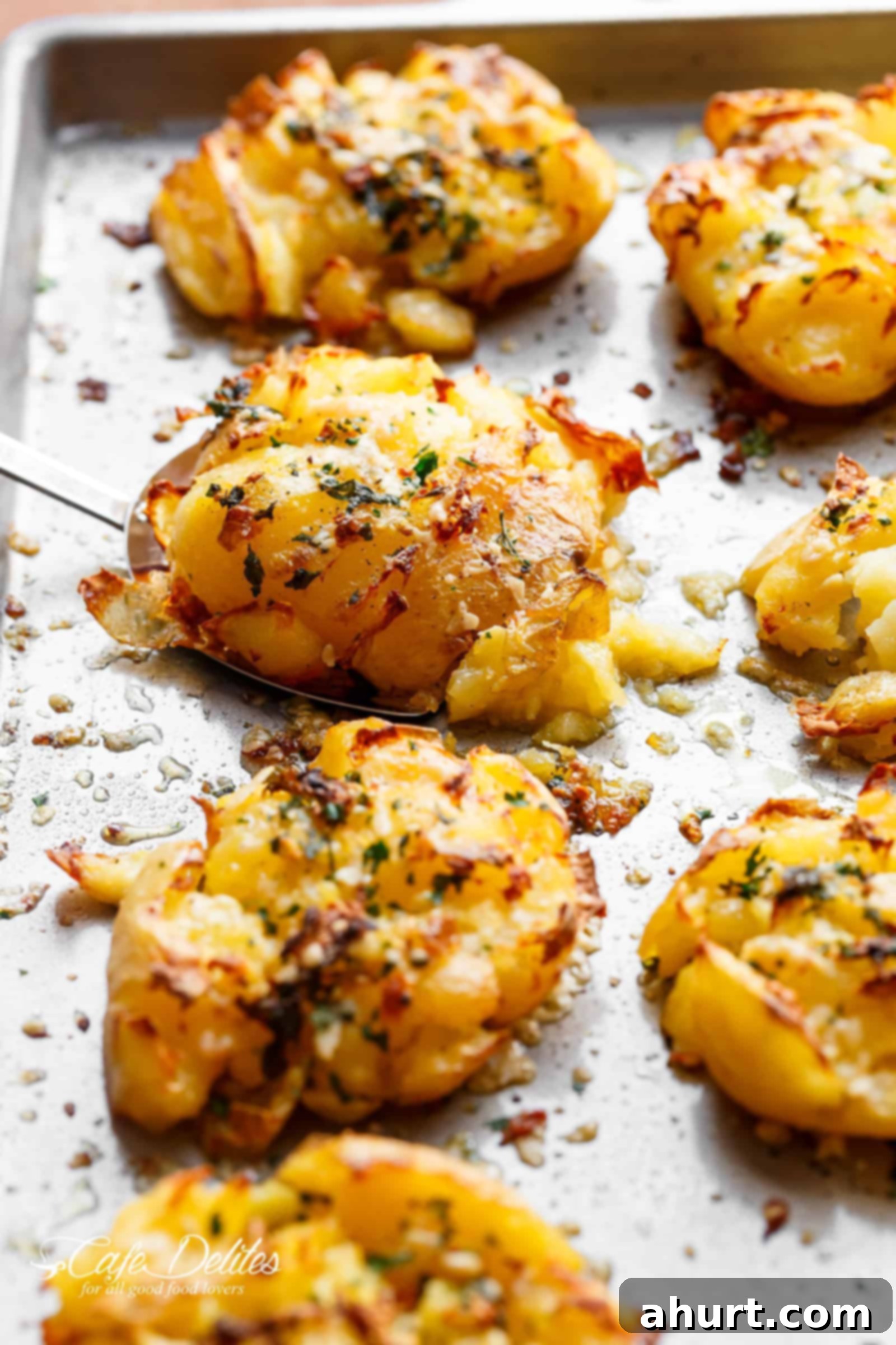 Ultimate Crispy Garlic Butter Parmesan Smashed Potatoes 6 Oven-baked crispy garlic butter parmesan smashed potatoes arranged on a baking tray, ready to be served.
