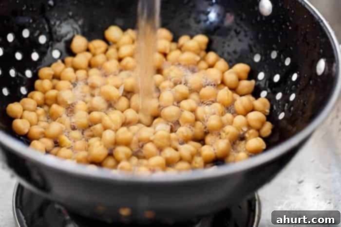 Vibrant Balsamic Chickpea Avocado Feta Salad 4 Close-up of thoroughly rinsed chickpeas in a bowl, ready for salad preparation.