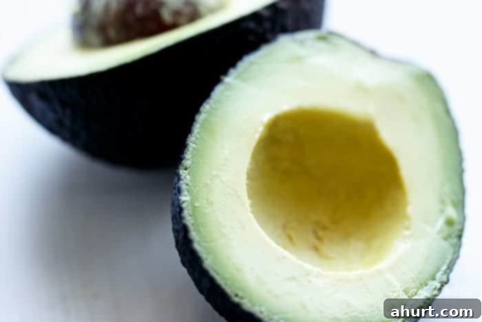 Vibrant Balsamic Chickpea Avocado Feta Salad 5 A perfectly ripe hass avocado, halved and ready for chopping into the salad.