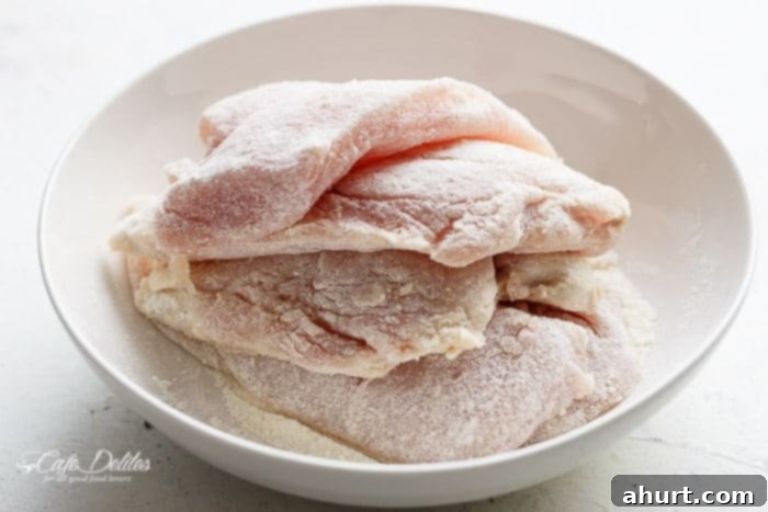 Velvety Lemon Parmesan Chicken 5 Cooked chicken slices stacked in a bowl