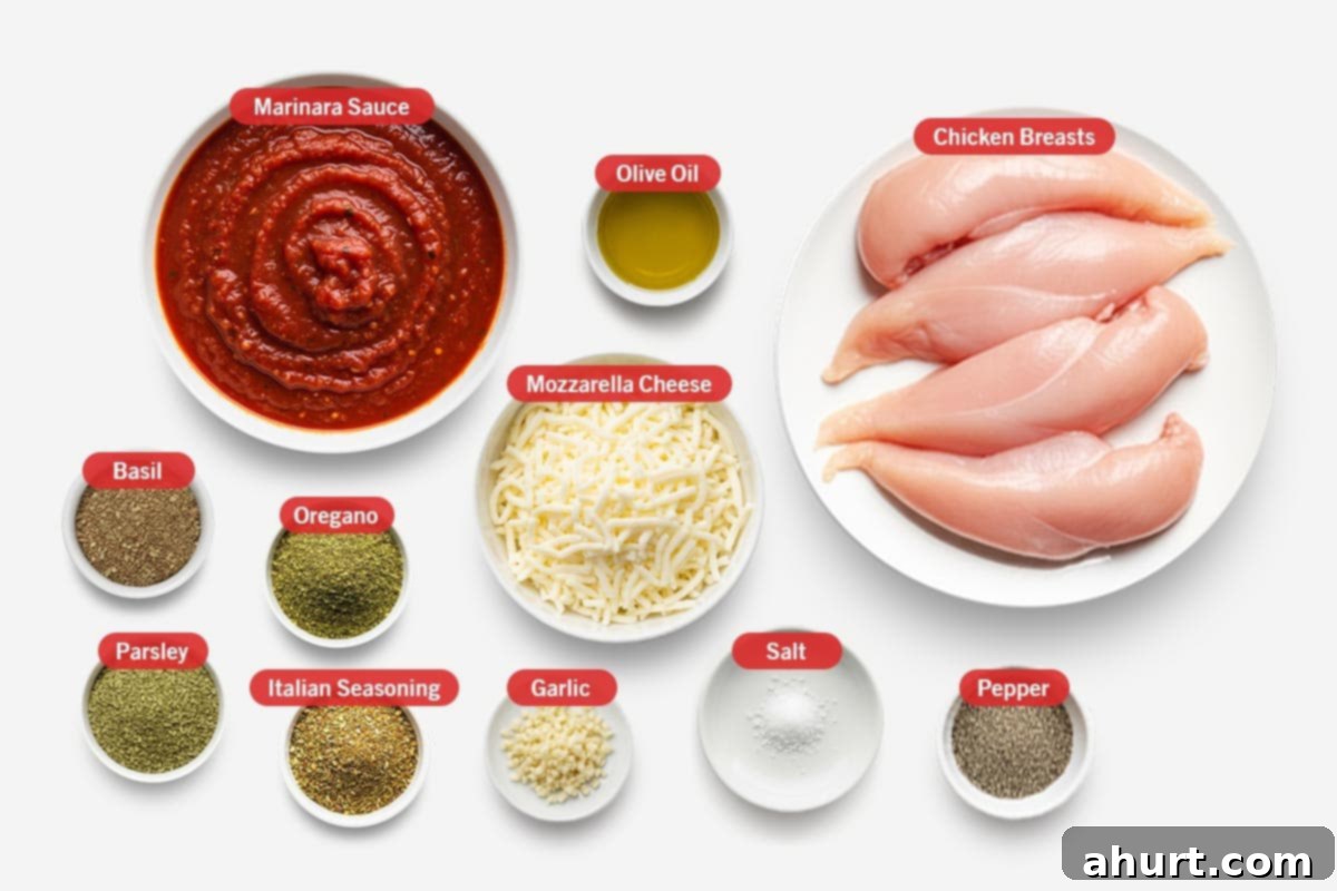 Chicken Mozzarella 3 Top-down view of fresh ingredients for Mozzarella Chicken: Chicken breasts, marinara sauce, olive oil, basil, oregano, shredded mozzarella cheese, fresh parsley, Italian seasoning, minced garlic, salt, and black pepper, arranged neatly on a wooden surface.