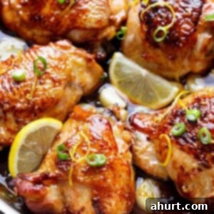 Honey Lemon Garlic Chicken pieces with lemon wedges