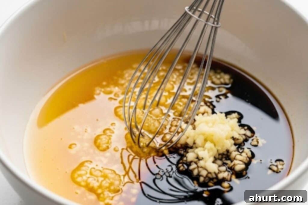 Whisking together honey, lemon juice, soy sauce, vinegar, and minced garlic for the marinade.