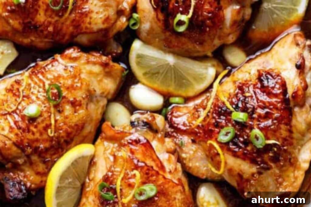 Finished Honey Lemon Garlic Chicken garnished with lemon slices and green onions, ready to serve.
