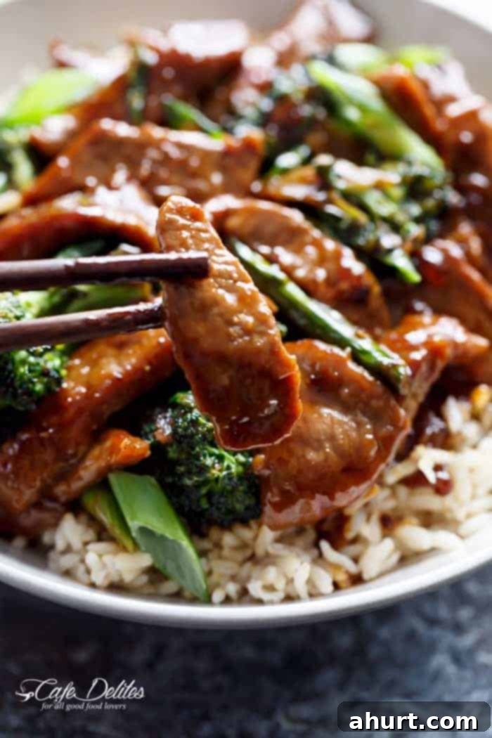 Extra Saucy Mongolian Beef and Broccoli 12 Image focusing on a beef piece from Mongolian Beef And Broccoli with rice in bowl