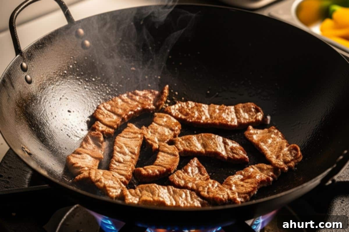 Extra Saucy Mongolian Beef and Broccoli 6 Cooking the beef in a wok.