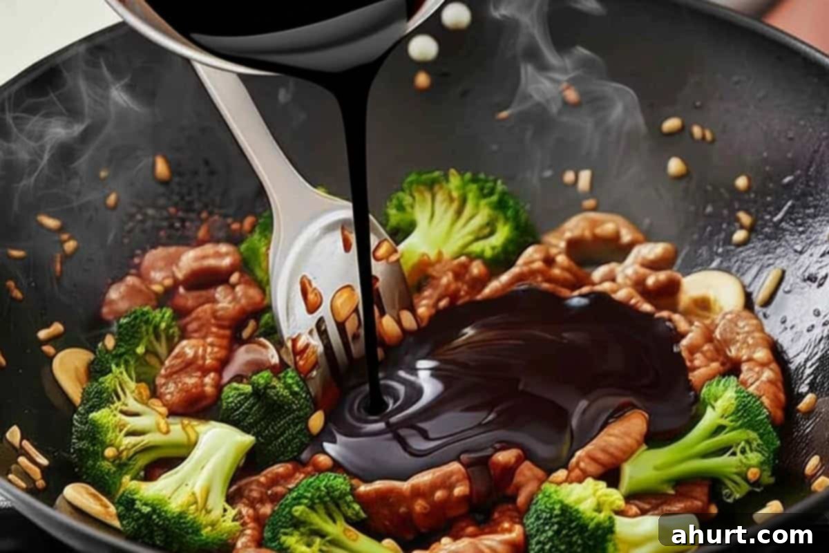 Extra Saucy Mongolian Beef and Broccoli 9 Pouring in the prepared sauce to the broccoli and cooked beef.