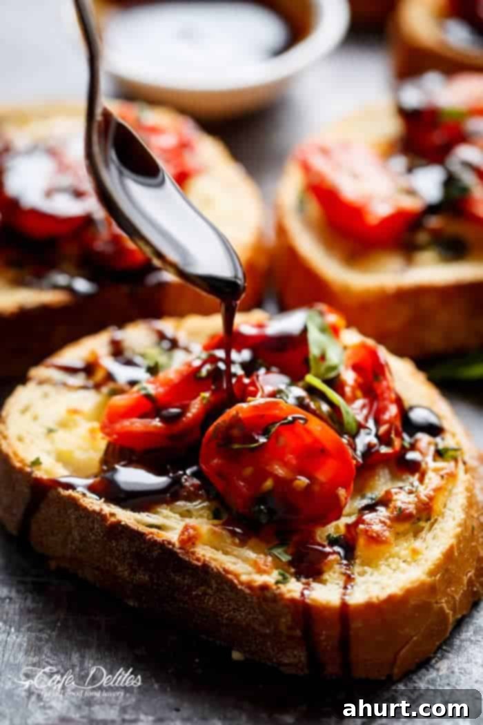 Caprese-Style Garlic Bread 3 A sauce dripping over Tomato Caprese Garlic Breads