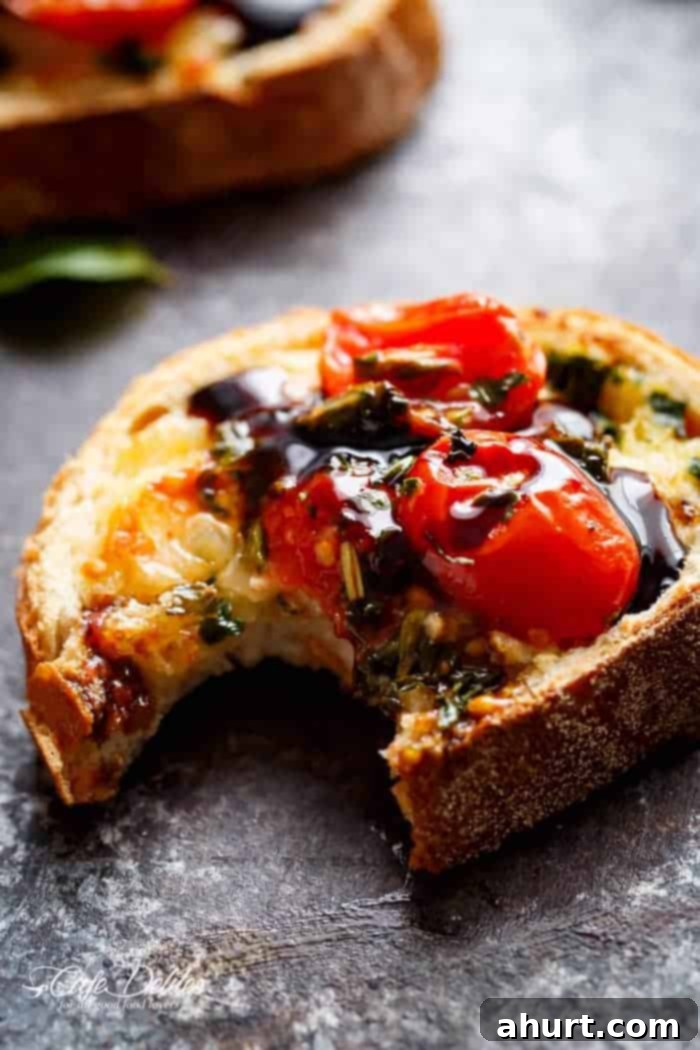 Caprese-Style Garlic Bread 5 A bite taken from Tomato Caprese Garlic Breads