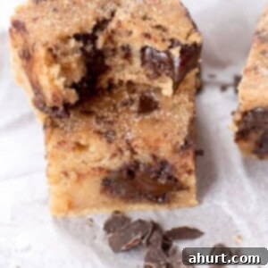 Cinnamon Sugar Chocolate Chunk Blondies 8 Churro Chocolate Chunk Blondies pieces on butter paper