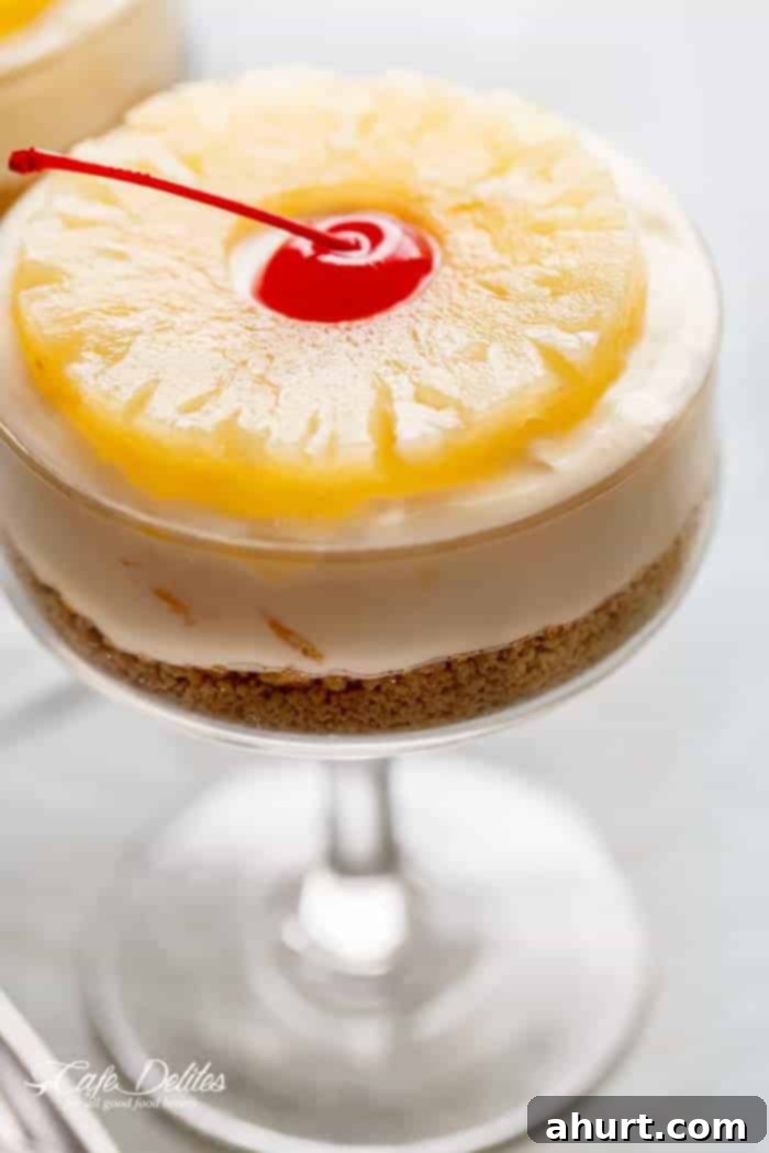 Side view of a single No-Bake Pineapple Cheesecake, showcasing its distinct layers and creamy texture