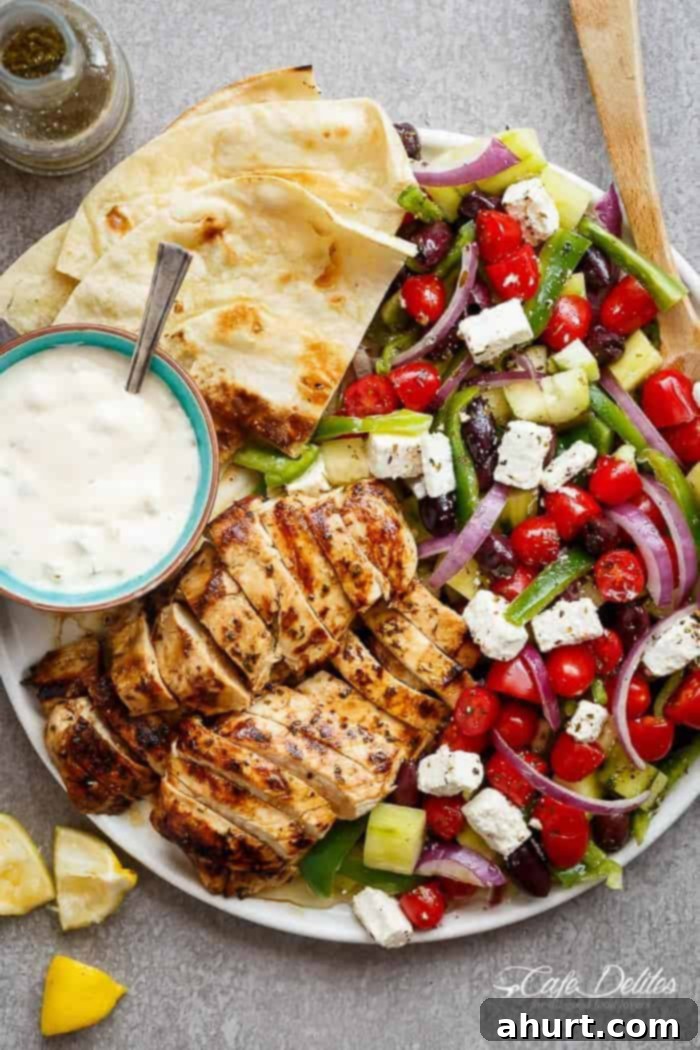 Greek Lemon Garlic Chicken Salad with an incredible dressing that doubles as a marinade! Complete with Tzatziki and homemade flatbreads, it's a winner!